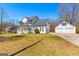 Charming two-story home with a covered porch, a detached two-car garage, and a well-manicured lawn at 821 Hood Rd, Fayetteville, GA 30214