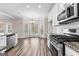 Open kitchen with stainless steel appliances and granite countertops flowing into a dining nook at 821 Hood Rd, Fayetteville, GA 30214