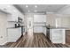 Bright kitchen features white cabinets, subway tile backsplash, stainless appliances, and wood-look floors at 821 Hood Rd, Fayetteville, GA 30214
