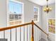 Upstairs landing with natural light, hardwood floors, and modern chandelier at 821 Hood Rd, Fayetteville, GA 30214