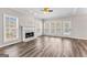 Sun-filled living room with modern flooring, marble fireplace, and natural light at 821 Hood Rd, Fayetteville, GA 30214