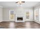 Bright living room boasts a marble fireplace, elegant molding, and wood-look flooring at 821 Hood Rd, Fayetteville, GA 30214
