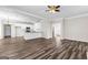 Open-concept living space shows kitchen with bar and seamlessly flows to living room with fireplace at 821 Hood Rd, Fayetteville, GA 30214