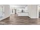 Charming living and kitchen area with modern flooring, white cabinets, and stainless steel appliances at 821 Hood Rd, Fayetteville, GA 30214