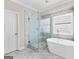 Modern main bathroom features a glass-enclosed shower and a luxurious soaking tub at 821 Hood Rd, Fayetteville, GA 30214