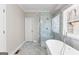 Modern main bathroom features a glass-enclosed shower and a luxurious soaking tub at 821 Hood Rd, Fayetteville, GA 30214