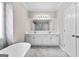 Bright bathroom with double vanity, large mirror, soaking tub, and tiled flooring at 821 Hood Rd, Fayetteville, GA 30214