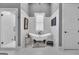 An elegant bathroom has a soaking tub, wainscoting, marble floors, and a glass shower at 1110 Blair Ln, Peachtree City, GA 30269