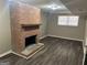 The finished basement features a brick fireplace and wood look flooring at 6625 Paula Ct, Lithonia, GA 30038