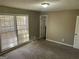 Bright bedroom with carpet, neutral walls, and large windows allowing natural light at 6625 Paula Ct, Lithonia, GA 30038