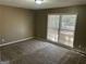 Cozy bedroom featuring carpeted floors, neutral walls, and a bright window at 6625 Paula Ct, Lithonia, GA 30038