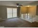 Open living room featuring neutral paint, carpeted floors, and a ceiling fan at 6625 Paula Ct, Lithonia, GA 30038