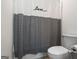 Bathroom featuring a toilet and shower with a gray and white decorative shower curtain at 1278 Heritage Dr, Villa Rica, GA 30180