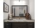 Granite countertop bathroom vanity with framed mirror and rustic decor at 1278 Heritage Dr, Villa Rica, GA 30180