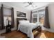 Comfortable bedroom with a ceiling fan, natural light, and hardwood flooring at 1278 Heritage Dr, Villa Rica, GA 30180