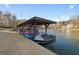 Lakeside boat dock with jet ski and kayaks at 1278 Heritage Dr, Villa Rica, GA 30180