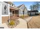 Charming gray home with stone accents, a sidewalk, and landscaped shrubs at 1278 Heritage Dr, Villa Rica, GA 30180