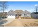 Attractive gray home with a well-manicured lawn and an attached garage near a lake at 1278 Heritage Dr, Villa Rica, GA 30180