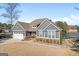 Charming gray home with a well-manicured lawn, attached garage, and beautiful landscaping at 1278 Heritage Dr, Villa Rica, GA 30180