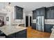 Modern kitchen featuring sleek cabinetry, stainless steel appliances, and an eat in breakfast bar at 1278 Heritage Dr, Villa Rica, GA 30180