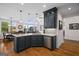 Open-concept kitchen with granite countertops, breakfast bar, and seamless flow to living and dining area at 1278 Heritage Dr, Villa Rica, GA 30180