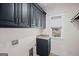 Modern laundry room with dark cabinets, granite countertops, a window, and luxury finishes at 1278 Heritage Dr, Villa Rica, GA 30180