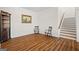 Open-concept living room with wood floors, staircase, and traditional furniture at 1278 Heritage Dr, Villa Rica, GA 30180