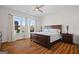 Spacious main bedroom features a ceiling fan, wood floors, and large windows with natural light at 1278 Heritage Dr, Villa Rica, GA 30180
