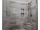 Modern walk-in shower features tile surround, built-in niche, and bench seating at 1278 Heritage Dr, Villa Rica, GA 30180