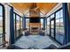 This sunroom features a wooden ceiling, stone fireplace, and lake views at 1278 Heritage Dr, Villa Rica, GA 30180