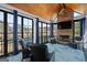 Relaxing sunroom features a cozy stone fireplace and scenic lake views at 1278 Heritage Dr, Villa Rica, GA 30180