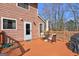 A wooden back deck offers outdoor enjoyment with outdoor furniture, a grill, and a door to the home at 110 Paces Dr, Fayetteville, GA 30215