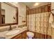Cozy bathroom featuring a granite countertop, tile flooring and tub-shower combo at 110 Paces Dr, Fayetteville, GA 30215