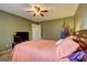 Bedroom with carpet, paint, dresser, tv, bed, window, and doors at 110 Paces Dr, Fayetteville, GA 30215