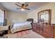 A cozy bedroom featuring ceiling fan, and natural light, with a neutral palette and furniture at 110 Paces Dr, Fayetteville, GA 30215