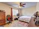 Neutral-toned bedroom with ceiling fan, a window providing natural light, and a TV for a relaxing space at 110 Paces Dr, Fayetteville, GA 30215