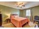 Bedroom with carpet, paint, bedside table, lamp, bed, window, curtains, and chair at 110 Paces Dr, Fayetteville, GA 30215