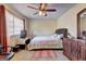 A bright bedroom featuring a ceiling fan and natural light, with a neutral palette and functional layout at 110 Paces Dr, Fayetteville, GA 30215
