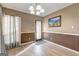 Bright dining room features hardwood floors, modern lighting and view of the backyard at 110 Paces Dr, Fayetteville, GA 30215