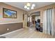 Open dining room featuring hardwood floors, neutral walls, and flows into a living room at 110 Paces Dr, Fayetteville, GA 30215