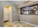 Neutral-toned entryway boasts tiled flooring, coat closet and servery opening to another room at 110 Paces Dr, Fayetteville, GA 30215