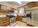 Well-equipped kitchen with stainless steel appliances and wood cabinets at 110 Paces Dr, Fayetteville, GA 30215