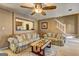 Bright living room with hardwood floors, ceiling fan, and views of the staircase at 110 Paces Dr, Fayetteville, GA 30215