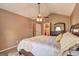 Warm primary bedroom featuring an ensuite bathroom, vaulted ceilings, and traditional furnishings at 110 Paces Dr, Fayetteville, GA 30215
