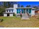 Back exterior featuring a sunroom addition, patio, and a fenced yard for outdoor enjoyment and privacy at 342 Lakeshore Dr, Stockbridge, GA 30281