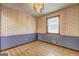 Cozy bedroom featuring floral wallpaper and wood-trimmed windows at 342 Lakeshore Dr, Stockbridge, GA 30281