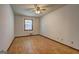 Neutral bedroom with hardwood floors, a window, and a ceiling fan at 342 Lakeshore Dr, Stockbridge, GA 30281