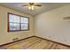 Bedroom with hardwood floors, a window, and a ceiling fan at 342 Lakeshore Dr, Stockbridge, GA 30281