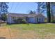 Charming single-story home with a well-maintained lawn and a chain-link fence under a clear blue sky at 342 Lakeshore Dr, Stockbridge, GA 30281