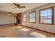Living room featuring water view from large windows and brick fireplace at 342 Lakeshore Dr, Stockbridge, GA 30281